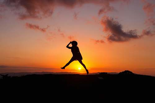 new zealand silhouette of human jumping during sunset woman